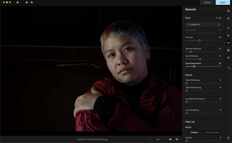 A person with short hair and a red jacket poses against a dark background; photo editing software with retouching options is visible on the right side of the screen.