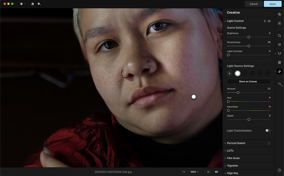 A photo editing software interface displays a close-up portrait of a person with adjustment sliders and creative settings visible on the right side of the screen.