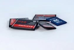 Assorted sd and microsd memory cards displayed on a white surface.