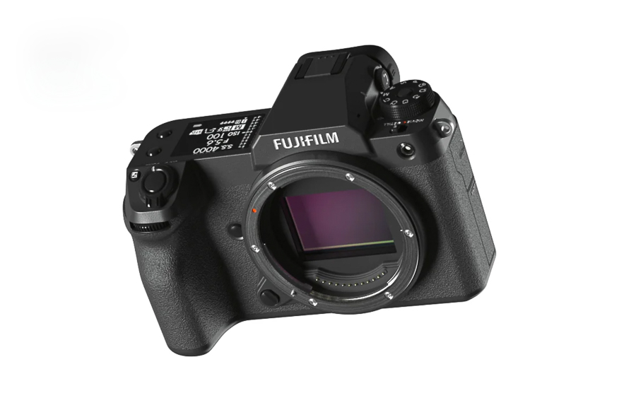 A Fujifilm digital camera body without a lens attached, showing its sensor and various control dials.