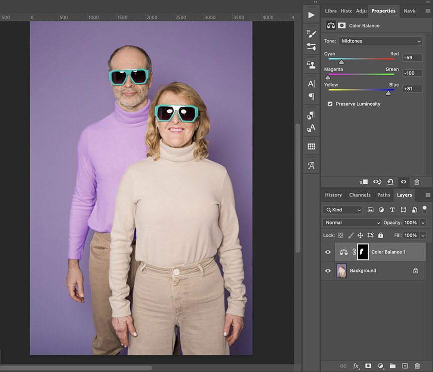 A man and a woman wearing sunglasses and turtlenecks stand in front of a purple background; Photoshop editing tools are visible on the right side of the screen.